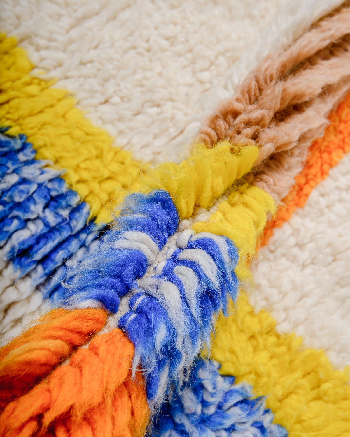 Detail of wool berber rug showing depth of pile and different coloured wool used.